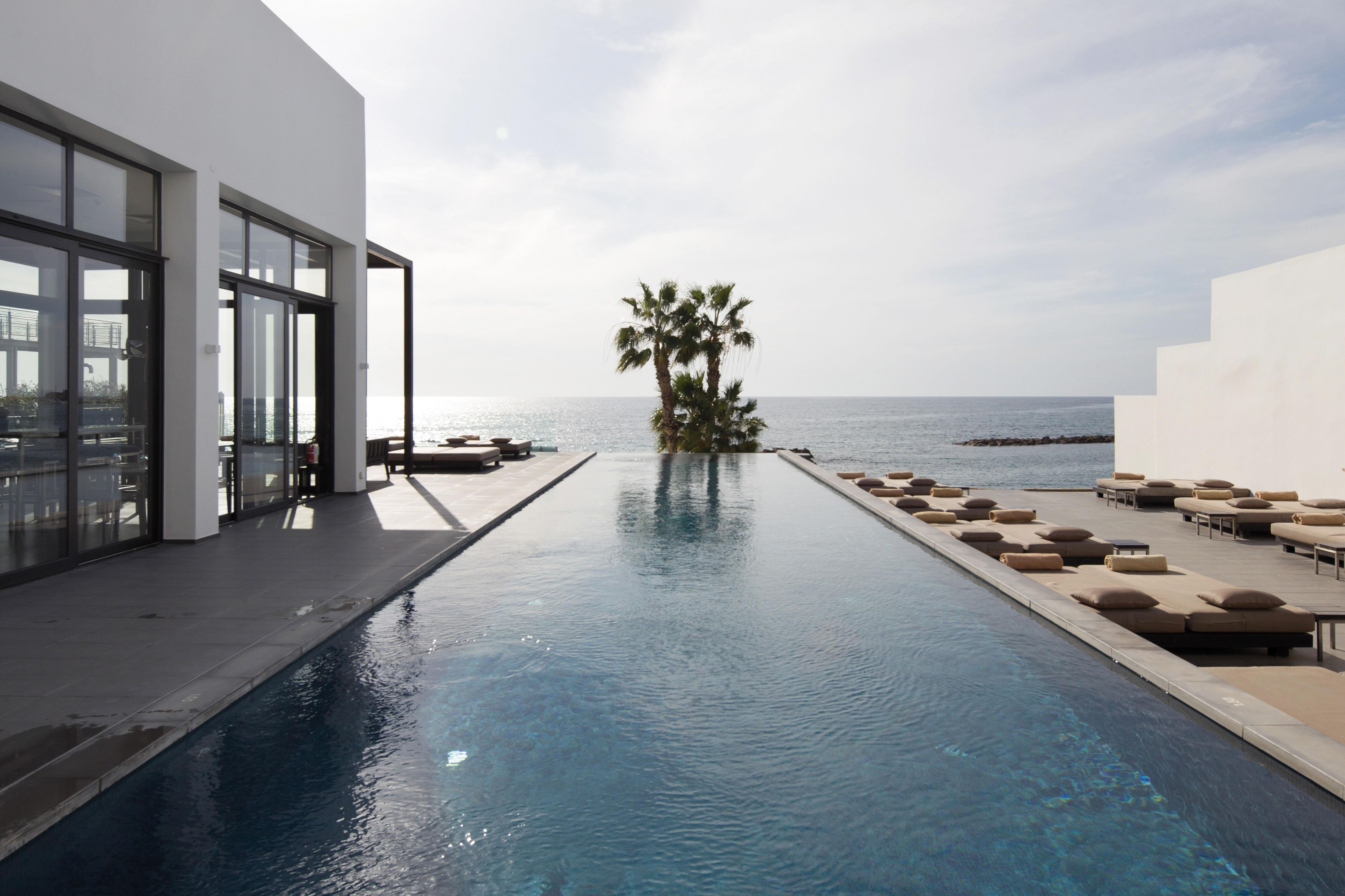 Almyra Hotel Paphos Bagian luar foto The pool at the Hotel