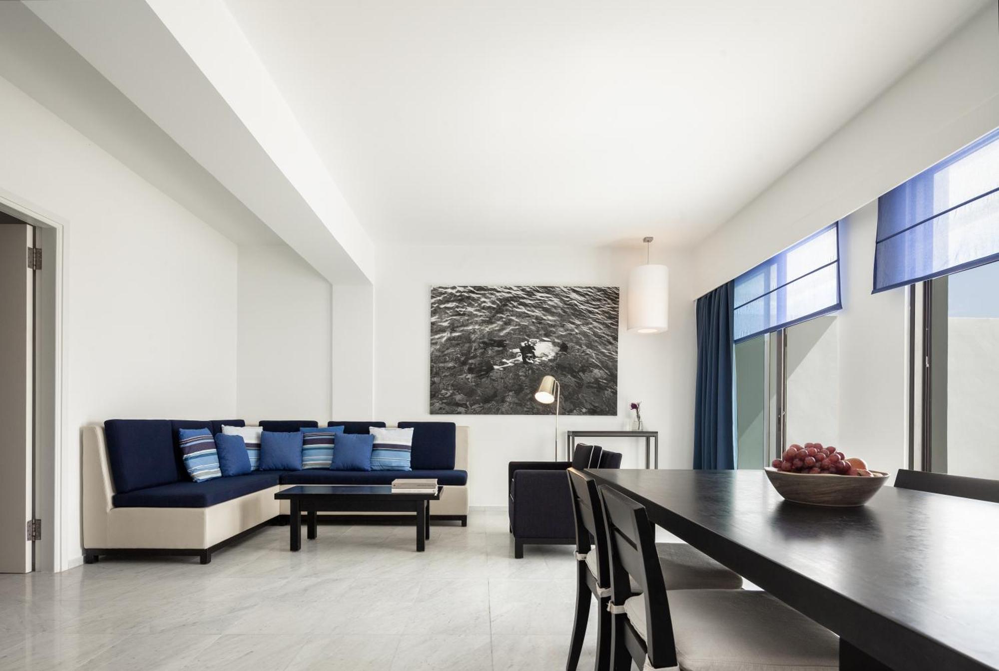Almyra Hotel Paphos Bagian luar foto A living room in a suite at the hotel