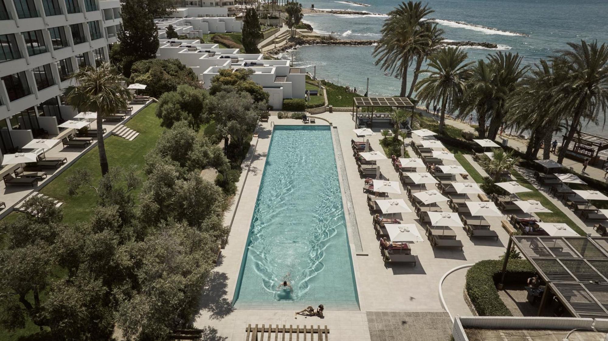 Almyra Hotel Paphos Bagian luar foto The pool at the Royal